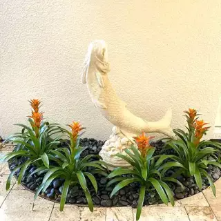 Garden with statue of a fish - hoa gardening services